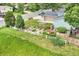 Aerial view of backyard with raised garden beds and patio seating area on a lush, green lawn at 10869 W 65Th Way, Arvada, CO 80004