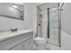 Well-lit bathroom featuring modern fixtures, including a glass-enclosed shower and sleek vanity at 10869 W 65Th Way, Arvada, CO 80004