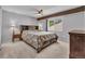 Brightly lit bedroom with exposed beam, complemented by a large bed and ample natural light at 10869 W 65Th Way, Arvada, CO 80004