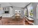 Bright dining area features wood floors, large windows, and built-in cabinets with glass doors at 10869 W 65Th Way, Arvada, CO 80004