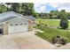 Home featuring a two-car garage, well-maintained lawn, and manicured garden in a quiet neighborhood at 10869 W 65Th Way, Arvada, CO 80004