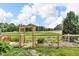 This garden has raised beds, stone pathways, wooden trellis, and is surrounded by a fence at 10869 W 65Th Way, Arvada, CO 80004