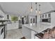 Bright kitchen boasts a large island with bar seating, stainless steel appliances, and ample counter space at 10869 W 65Th Way, Arvada, CO 80004