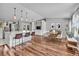 Open-concept kitchen and dining area featuring a large island, modern appliances, and wood flooring at 10869 W 65Th Way, Arvada, CO 80004