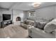 Spacious living room featuring a painted brick fireplace and comfortable neutral furnishings at 10869 W 65Th Way, Arvada, CO 80004