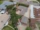 Aerial view of a home with a large backyard, deck, mature trees, and detached garage, offering privacy at 10335 W 18Th Pl, Lakewood, CO 80215