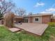 Spacious wood deck in backyard with outdoor seating and partial brick and siding home exterior at 10335 W 18Th Pl, Lakewood, CO 80215