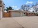 Spacious backyard featuring a large concrete patio area, detached garage with basketball hoop at 10335 W 18Th Pl, Lakewood, CO 80215