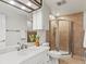 Bathroom featuring a white vanity with ample lighting and a walk-in shower at 10335 W 18Th Pl, Lakewood, CO 80215