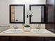 Well-lit bathroom featuring a double sink vanity with dark wood cabinets and tan countertop at 10335 W 18Th Pl, Lakewood, CO 80215