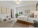Well-lit bedroom with a soft rug, modern lamps, neutral wall art, and plush bedding at 10335 W 18Th Pl, Lakewood, CO 80215