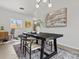 Bright dining room featuring a modern table, stylish lighting, and ample space for entertaining at 10335 W 18Th Pl, Lakewood, CO 80215