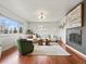 Inviting living room with hardwood floors, a fireplace, a comfortable sofa and abundant natural light at 10335 W 18Th Pl, Lakewood, CO 80215