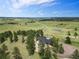 Home nestled among mature trees on a sprawling parcel with lush, green pastures at 1752 Private Road 130, Elizabeth, CO 80107