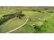 Expansive property featuring a main house, red barn, pond, and winding dirt road at 1752 Private Road 130, Elizabeth, CO 80107