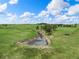 Small pond with trees on an expansive green property at 1752 Private Road 130, Elizabeth, CO 80107