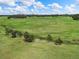 Aerial shot featuring a winding stream through verdant pasture, accented by mature trees and open space at 1752 Private Road 130, Elizabeth, CO 80107