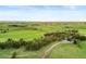 Scenic aerial photograph of lush green pastures with a home tucked amongst the trees, highlighting the property's tranquility at 1752 Private Road 130, Elizabeth, CO 80107