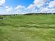 Expansive green acreage with scattered trees and a stream at 1752 Private Road 130, Elizabeth, CO 80107