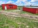 Two red storage buildings with a fenced area nearby at 1752 Private Road 130, Elizabeth, CO 80107
