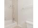 Bathroom with shower-tub combo and tiled walls at 1180 S Monaco Pkwy # 3, Denver, CO 80224