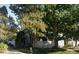 Charming townhouse with a white picket fence and mature trees providing shade and curb appeal at 1180 S Monaco Pkwy # 3, Denver, CO 80224