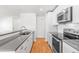 Modern kitchen featuring white cabinets, stainless steel appliances, and sleek countertops at 1180 S Monaco Pkwy # 3, Denver, CO 80224