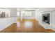 Spacious living room with a fireplace, hardwood floors, and an open layout at 1180 S Monaco Pkwy # 3, Denver, CO 80224