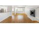 Bright living room with fireplace, and a view into the kitchen featuring white cabinets and stainless steel appliances at 1180 S Monaco Pkwy # 3, Denver, CO 80224