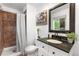 Updated bathroom featuring a tile shower, granite counters, and modern fixtures at 7132 Xavier Way, Westminster, CO 80030