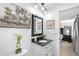 Updated bathroom with a modern vanity, black granite counters, and a decorative mirror at 7132 Xavier Way, Westminster, CO 80030