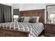 This bedroom boasts a substantial wood headboard, contemporary decor, and comfortable styling at 7132 Xavier Way, Westminster, CO 80030