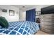 Bedroom with a plush bed, large TV, and decorative shelves at 7132 Xavier Way, Westminster, CO 80030