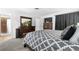 A bedroom featuring a large headboard, dresser with mirror, and ensuite bath access at 7132 Xavier Way, Westminster, CO 80030