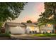 Evening shot of a well-kept two-story home, featuring a spacious front yard, wide driveway, and two-car garage at 7132 Xavier Way, Westminster, CO 80030