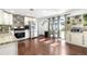 Well-lit kitchen featuring stainless steel appliances, hardwood floors, and access to the outdoor patio via glass doors at 7132 Xavier Way, Westminster, CO 80030