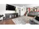Spacious living room with hardwood floors, modern furniture, and a large area rug at 7132 Xavier Way, Westminster, CO 80030