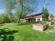 Expansive backyard featuring a well-maintained lawn, mature trees, and a spacious deck at 207 Iowa Dr, Golden, CO 80403