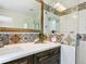 Bright bathroom with decorative tile detail, a glass enclosed shower, and modern fixtures at 207 Iowa Dr, Golden, CO 80403