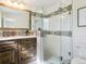 Updated bathroom with decorative tile detail, a glass enclosed shower, and modern fixtures at 207 Iowa Dr, Golden, CO 80403