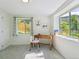 Sun-filled bedroom provides a desk and two large windows showcasing the greenery outside at 207 Iowa Dr, Golden, CO 80403