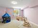 Playful bedroom with soft purple walls and carpeting, filled with toys and games at 207 Iowa Dr, Golden, CO 80403