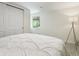 Neutrally decorated bedroom with large window, carpeting and white closet doors at 207 Iowa Dr, Golden, CO 80403