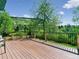 Spacious wooden deck with black metal railing overlooking a serene yard at 207 Iowa Dr, Golden, CO 80403