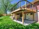 A house featuring a raised wood deck with a patio space below at 207 Iowa Dr, Golden, CO 80403