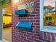 A brick house shows its street number and an older mailbox on the exterior wall at 207 Iowa Dr, Golden, CO 80403