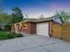 Exterior view of a red brick home with a clean driveway and a two car garage at 207 Iowa Dr, Golden, CO 80403