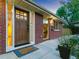 Charming brick home with a stylish front door, warm lighting, and lovely landscaping at 207 Iowa Dr, Golden, CO 80403
