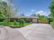 Brick home featuring a well-kept lawn and paved driveway leading to an attached garage at 207 Iowa Dr, Golden, CO 80403