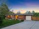 Brick home with a well-kept lawn, driveway, and an attached garage for added convenience at 207 Iowa Dr, Golden, CO 80403